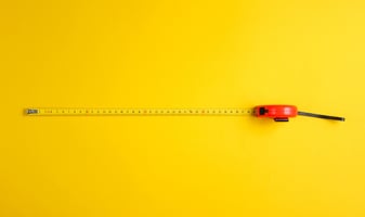 Yellow background with a measuring tape 